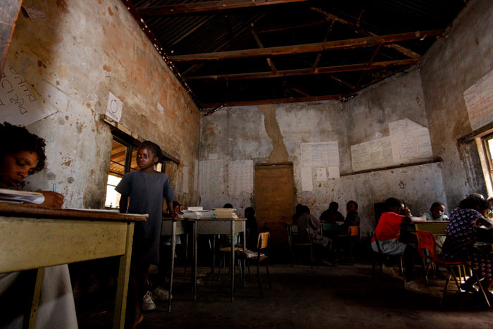 The classrooms were dark, the roof was rotting and regularly leaked...